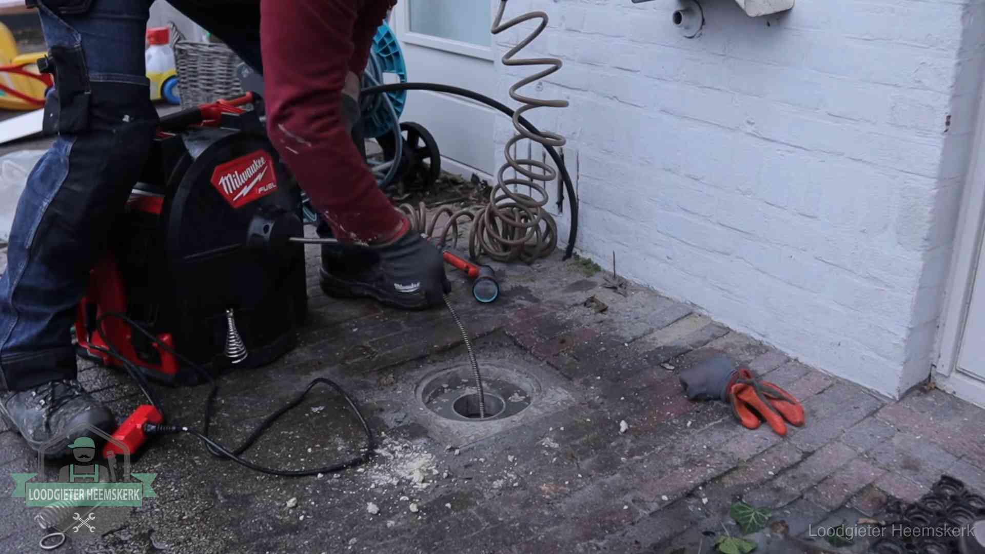 Prijs van een rioolontstopping in Heemskerk Spiraalmachine bij een ontstoppingsputje in de bestrating in Heemskerk