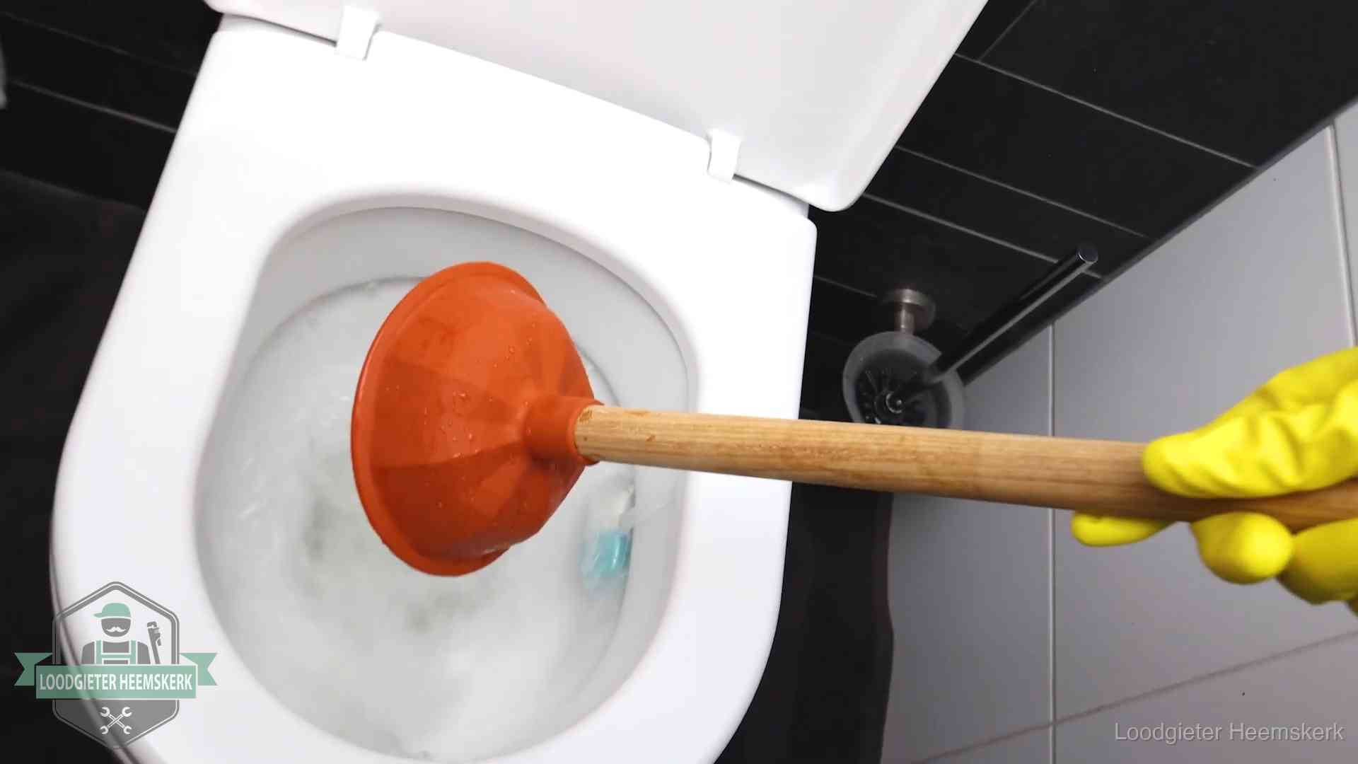 Wc ontstoppen met de plopper in Heemskerk Plopper wordt in de wc-pot gedrukt bij het ontstoppen van een toilet in Heemskerk